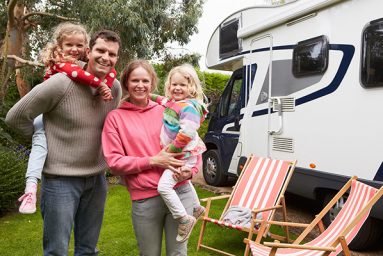 a happy family next to an RV