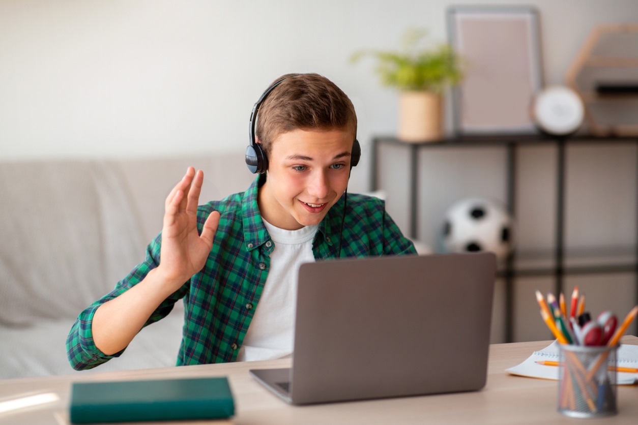 positive-teenager-having-video-conference-with-teacher-picture-id1267284127 positive-teenager-having-video-conference-with-teacher-picture-id1267284127